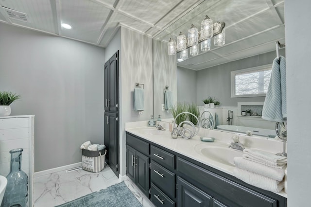 bathroom featuring a washtub and vanity