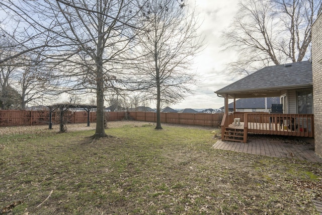 view of yard featuring a patio area and a wooden deck