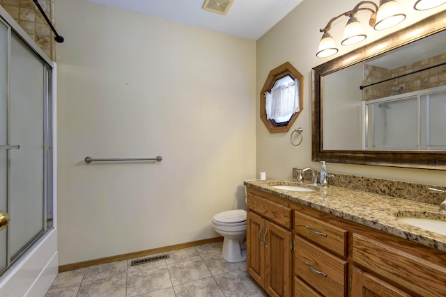 full bathroom with tile patterned flooring, vanity, toilet, and enclosed tub / shower combo