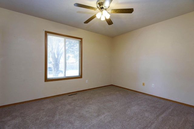 carpeted empty room featuring ceiling fan