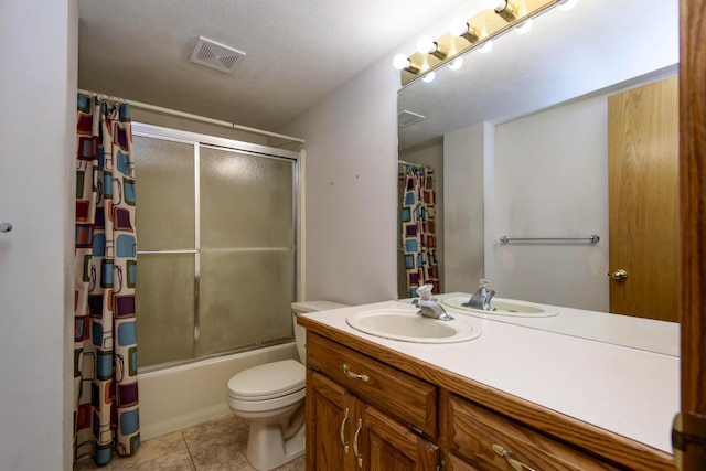 full bathroom with enclosed tub / shower combo, tile patterned floors, a textured ceiling, toilet, and vanity