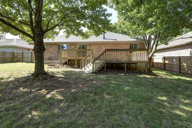 back of house with a lawn and a wooden deck