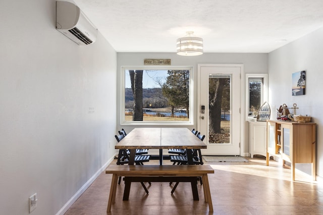 dining space featuring hardwood / wood-style floors, a wall mounted air conditioner, and a notable chandelier