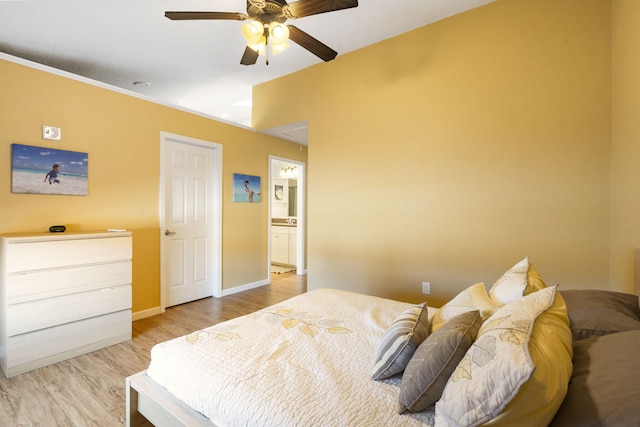 bedroom featuring ceiling fan, light wood-type flooring, and ensuite bath