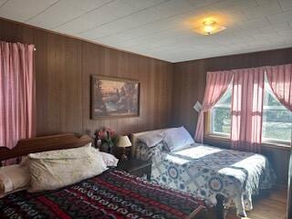 bedroom with wood walls