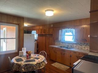 kitchen featuring backsplash, stove, and white refrigerator