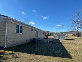 view of side of property with a lawn