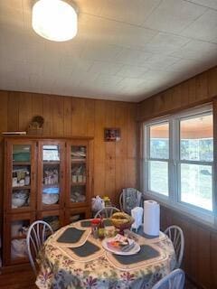 dining space with wood walls