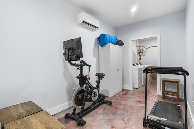 workout room with baseboards, separate washer and dryer, and a wall mounted AC