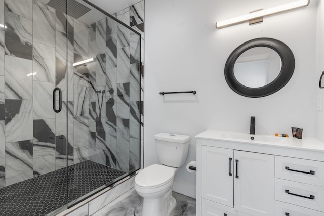bathroom featuring a stall shower, marble finish floor, vanity, and toilet