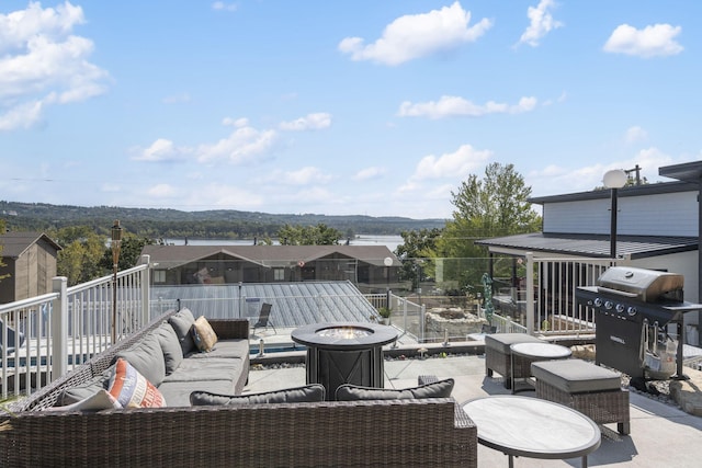 view of patio / terrace featuring a residential view, an outdoor living space with a fire pit, and area for grilling