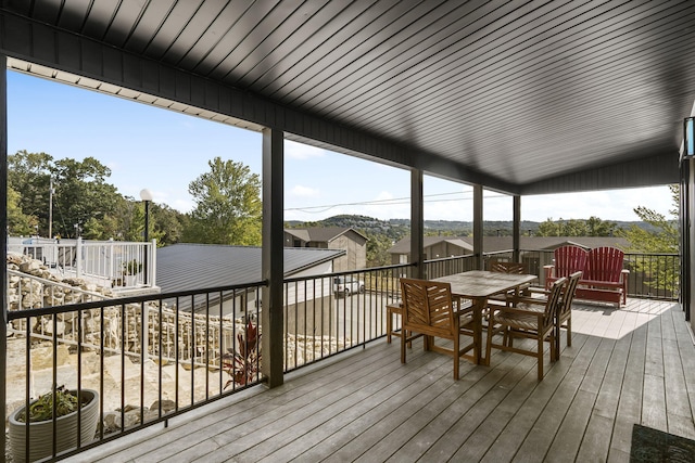 wooden terrace featuring outdoor dining area