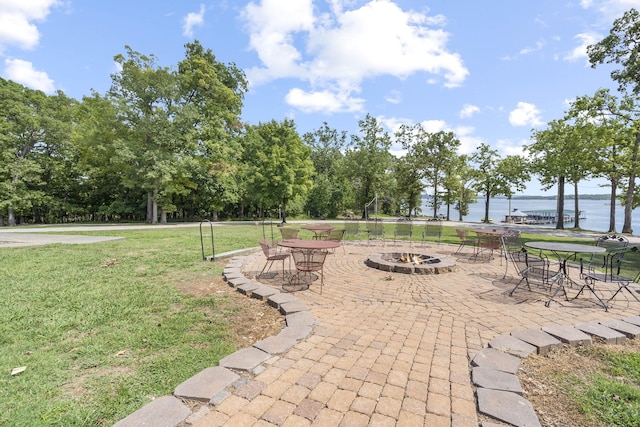 view of patio / terrace with a water view and an outdoor fire pit