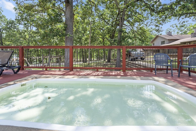 view of swimming pool with a deck