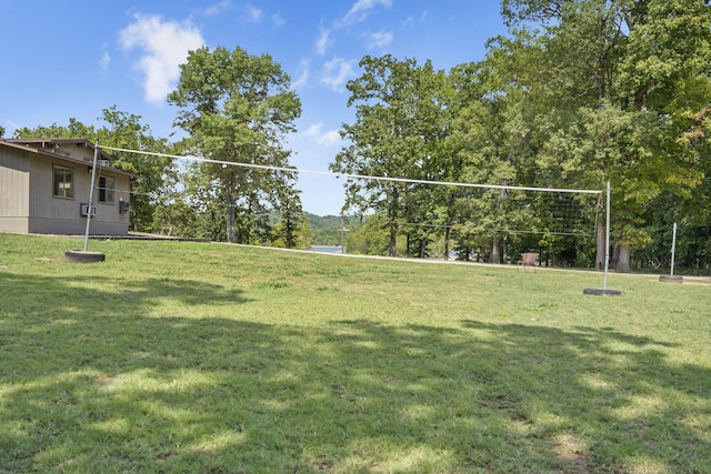view of community featuring a lawn and volleyball court