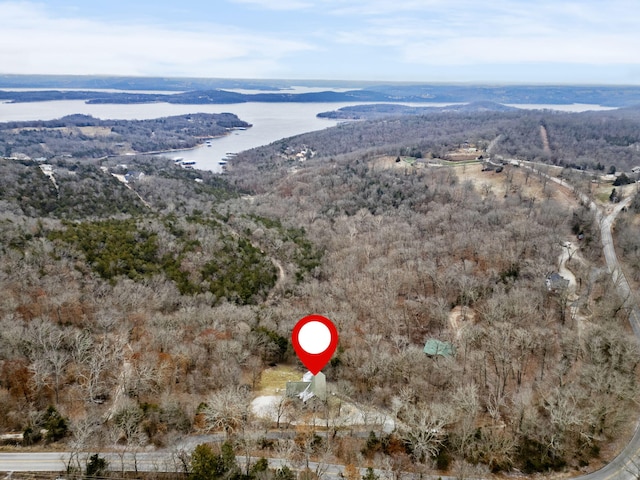 aerial view featuring a forest view and a water view