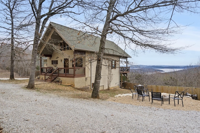 view of side of home with a fire pit and a deck