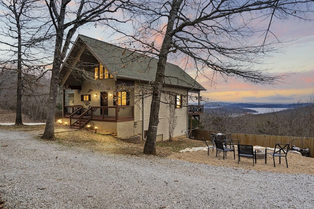 property exterior at dusk featuring a fire pit