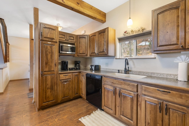 kitchen featuring dishwasher, stainless steel microwave, sink, beam ceiling, and dark hardwood / wood-style flooring