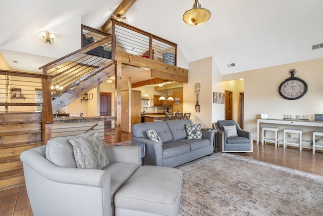 living room with beam ceiling, high vaulted ceiling, and hardwood / wood-style flooring