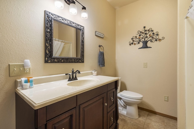 bathroom featuring tile patterned floors, vanity, and toilet