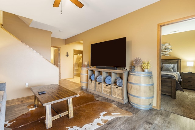 living room featuring hardwood / wood-style flooring and ceiling fan