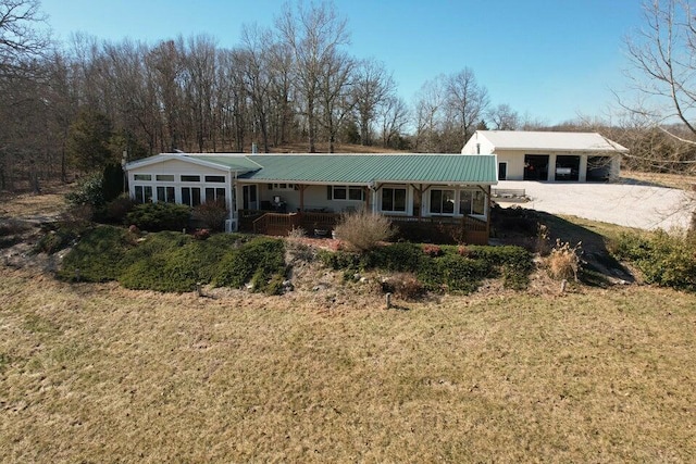 view of front of property with a carport, covered porch, and a front lawn