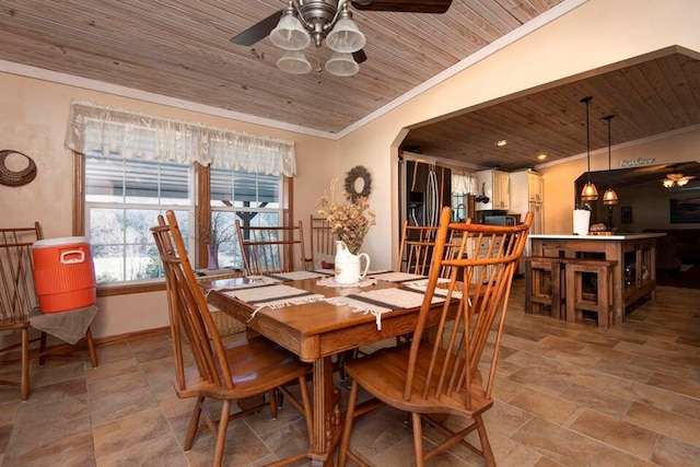 dining space featuring ceiling fan, ornamental molding, and wooden ceiling