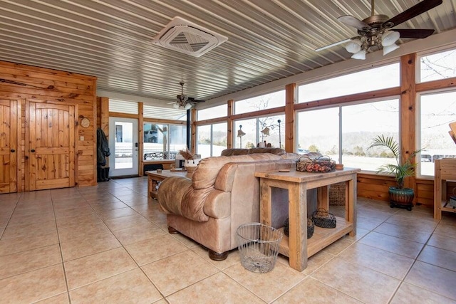 tiled living room with ceiling fan