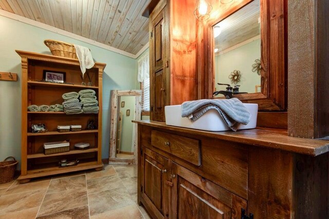 bathroom with wood ceiling, ornamental molding, and vanity