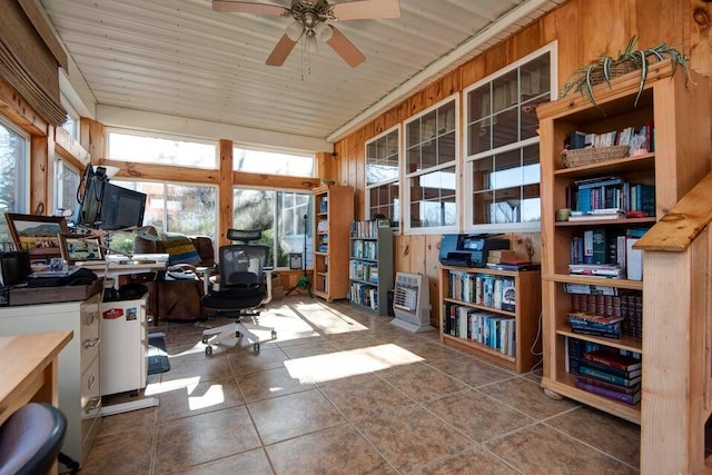 tiled office space featuring ceiling fan and wooden walls