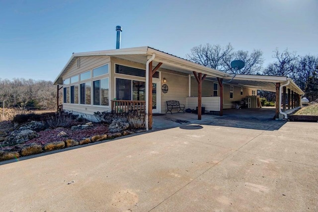 view of front of home featuring a sunroom and a carport