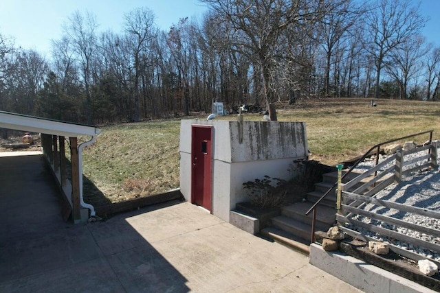 view of storm shelter with a yard