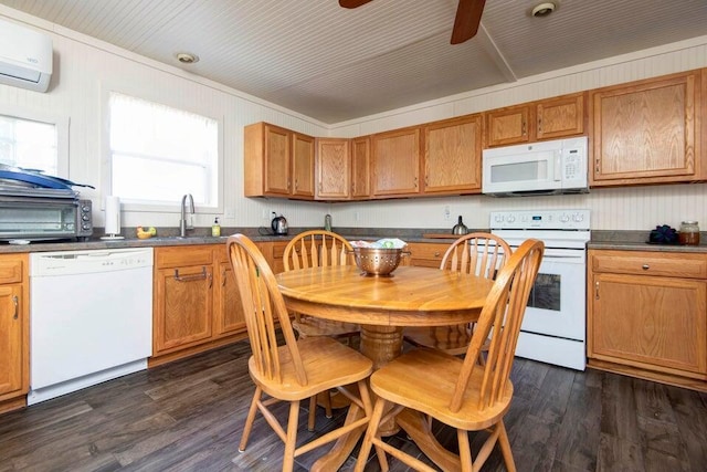 kitchen featuring dark wood-type flooring, sink, an AC wall unit, ceiling fan, and white appliances