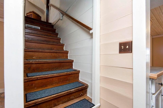 staircase with wood walls