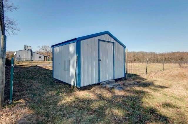 view of outbuilding with a yard and a rural view