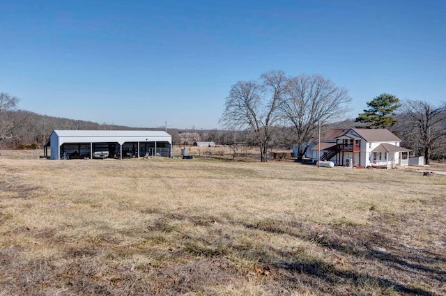 view of yard featuring a carport and a rural view