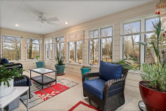 sunroom / solarium featuring ceiling fan