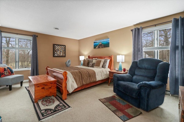 carpeted bedroom featuring a baseboard radiator