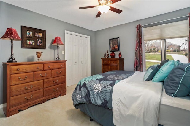 carpeted bedroom with ceiling fan, access to outside, and a closet