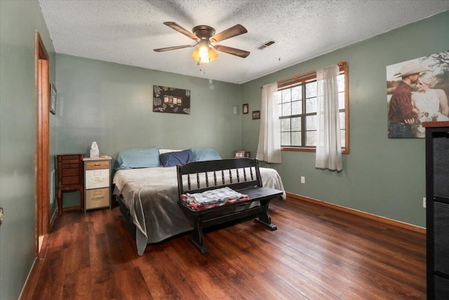 bedroom featuring a textured ceiling, ceiling fan, and dark wood-type flooring