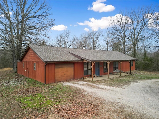 single story home with a garage and covered porch