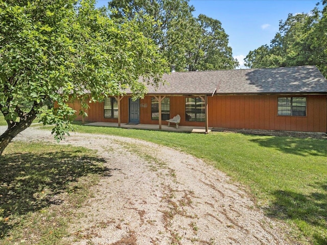 1588 US Highway 160, Caulfield, MO 65626 - view of front of house with dirt driveway, a front lawn, covered porch, and roof with shingles