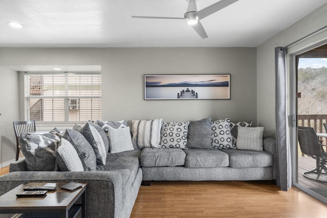 living room featuring hardwood / wood-style flooring and ceiling fan