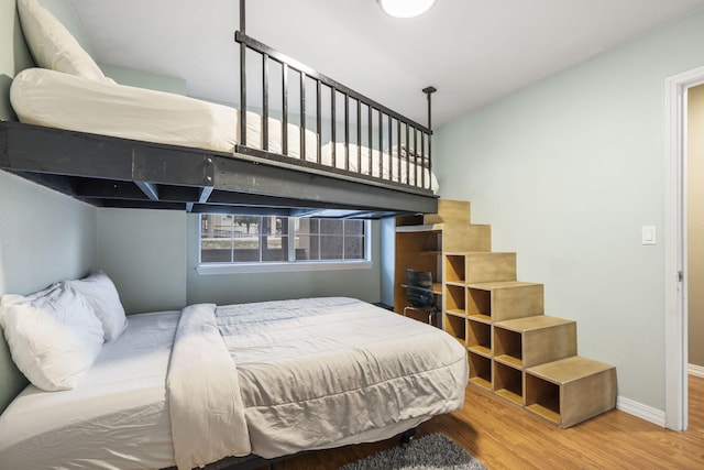 bedroom with hardwood / wood-style flooring