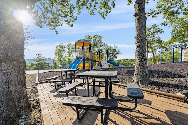 wooden deck featuring a playground