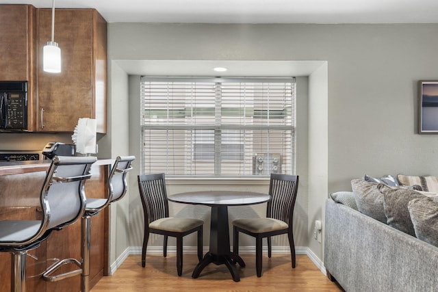 dining space with light hardwood / wood-style floors