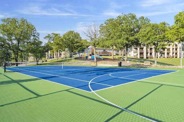 view of sport court with a playground and basketball hoop