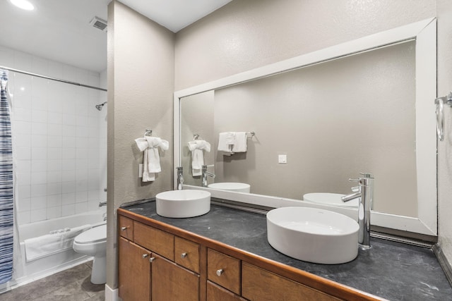 full bathroom featuring tile patterned flooring, shower / tub combo, vanity, and toilet