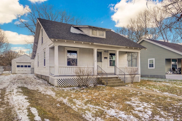 bungalow featuring an outbuilding, a porch, and a garage